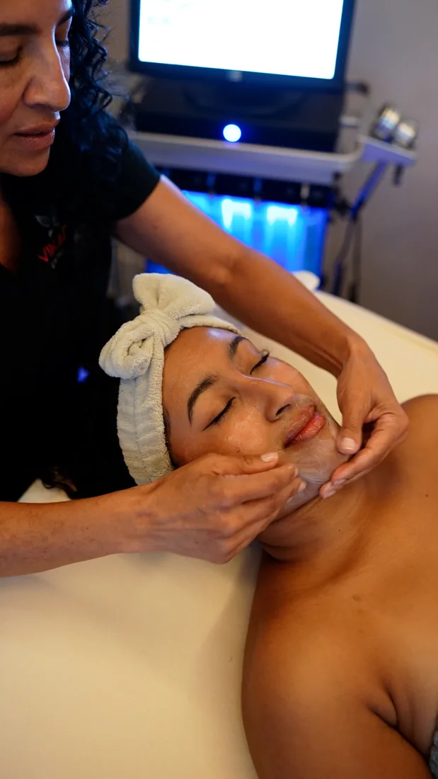A VIKARA clinician providing facial care