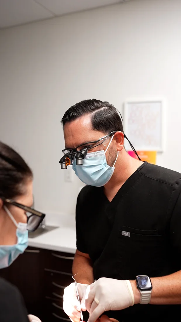 A dental clinician working with a patient