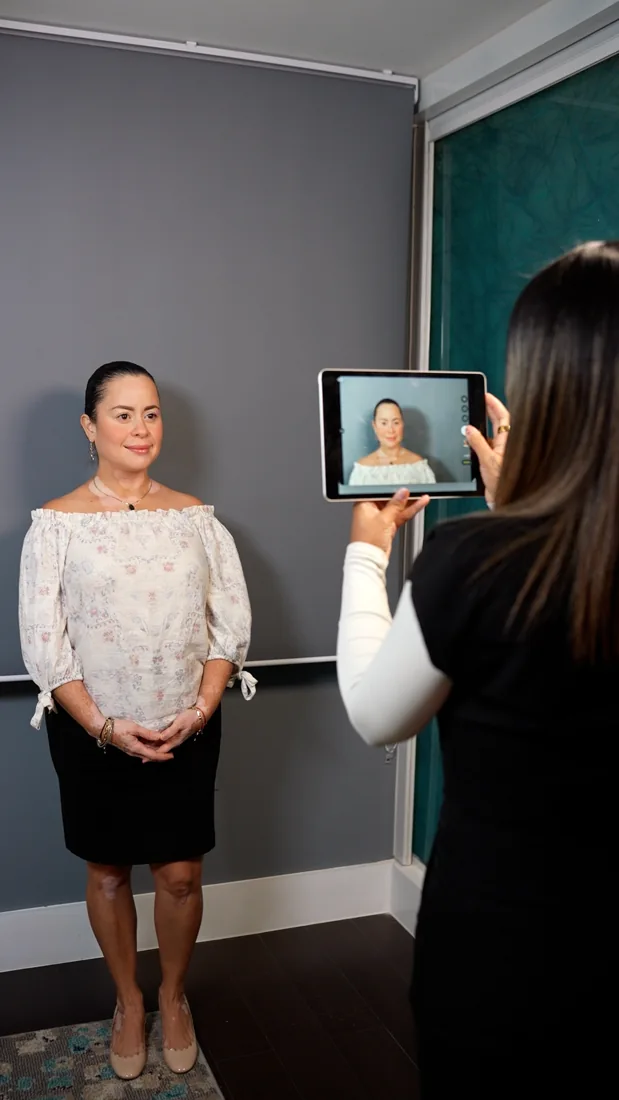 A member of the VIKARA team using a tablet during a patient assessment