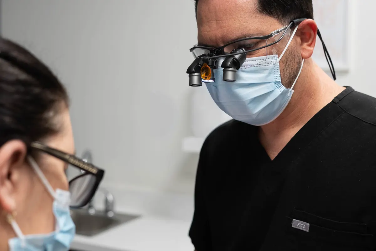 A VIKARA clinician working in loupes during a periodontal procedure