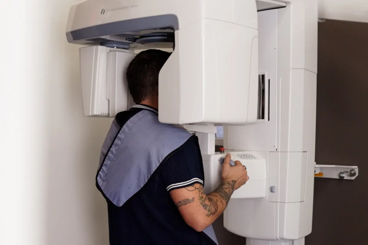 A patient positioned at VIKARA's panoramic imaging unit