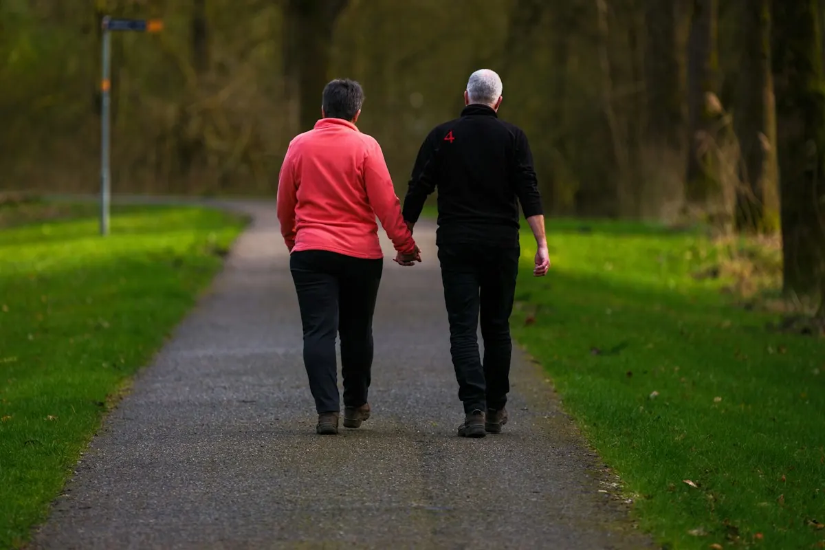 An older couple walking a path together