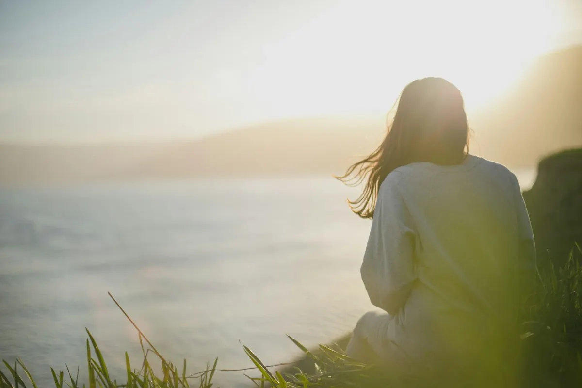 A woman looking out over open water
