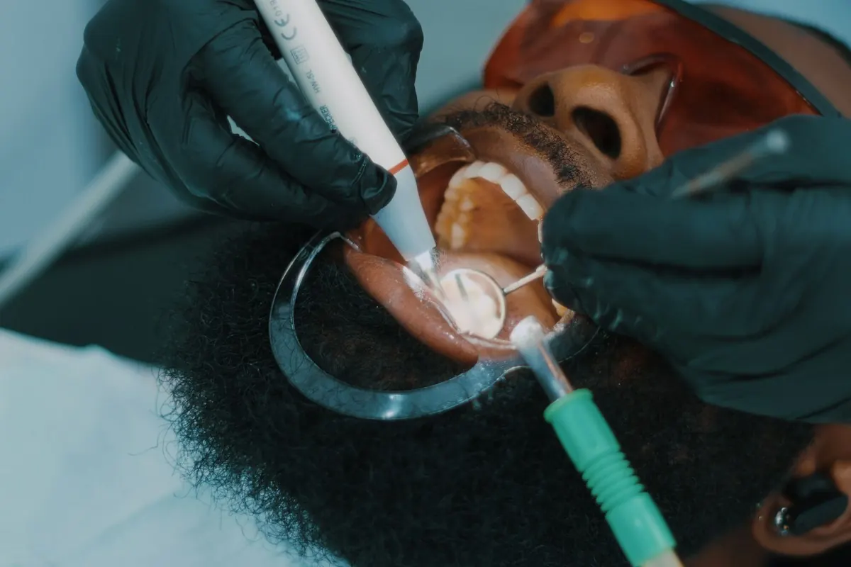 A clinician treating a tooth in a dental chair